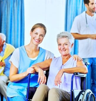 caregiver and disabled senior smiling