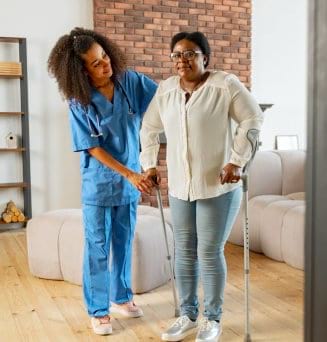 caregiver helping senior to stand