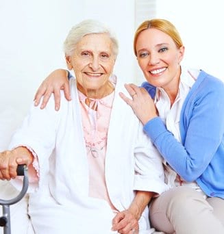 lady caregiver and senior smiling