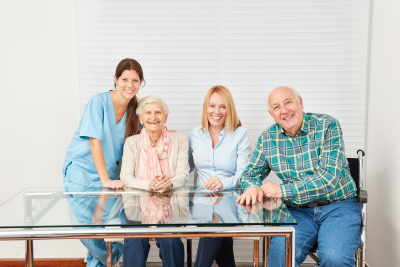 health care worker and elderly people taking photo