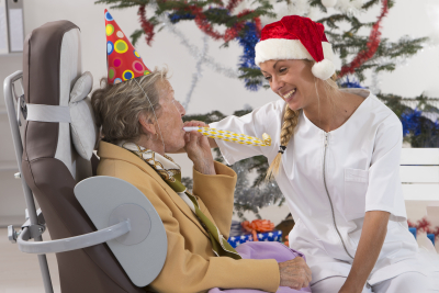 caregiver and senior woman having fun on a party